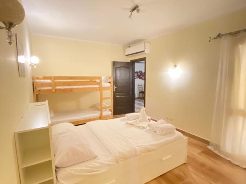One-bedroom apartment with pool view at Florenza Khamsin Hurghada featuring spacious layout and family-friendly bedding