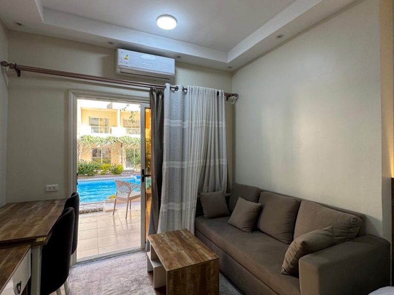 Studio with pool view at Florenza Khamsin Hurghada featuring 2 small beds, sofa bed, and ground floor access