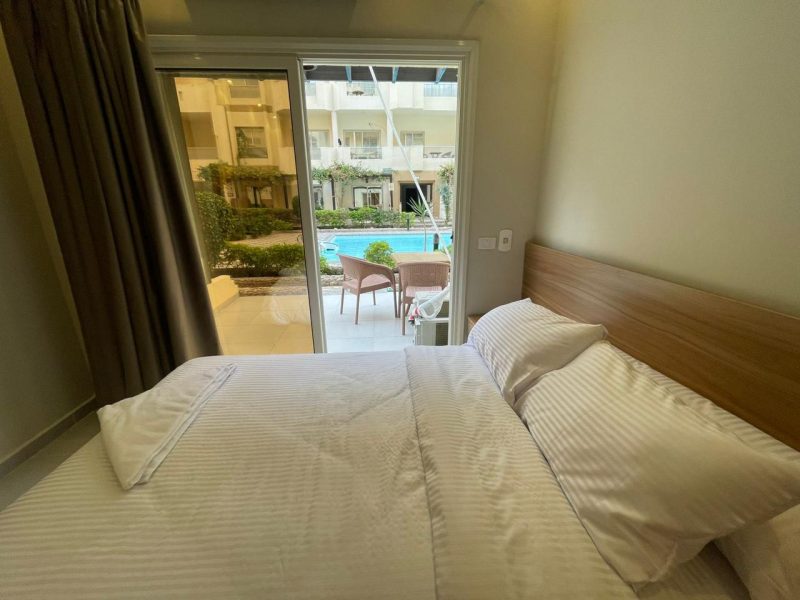 Studio with pool view at Florenza Khamsin Hurghada featuring 2 small beds, sofa bed, and ground floor access