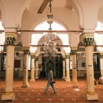 Travelers exploring a traditional market as part of cultural journeys, experiencing local crafts, food, and customs