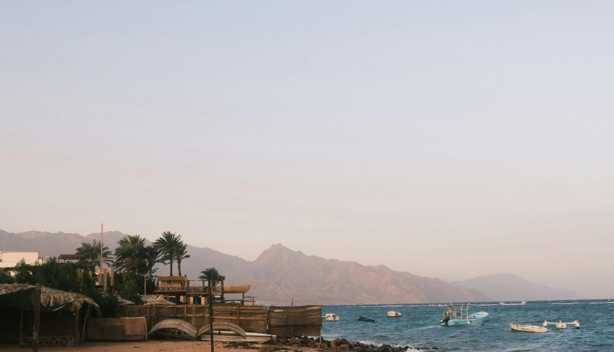 Dahab, Egypt Red Sea coastline with crystal-clear water, coral reefs, and desert mountains