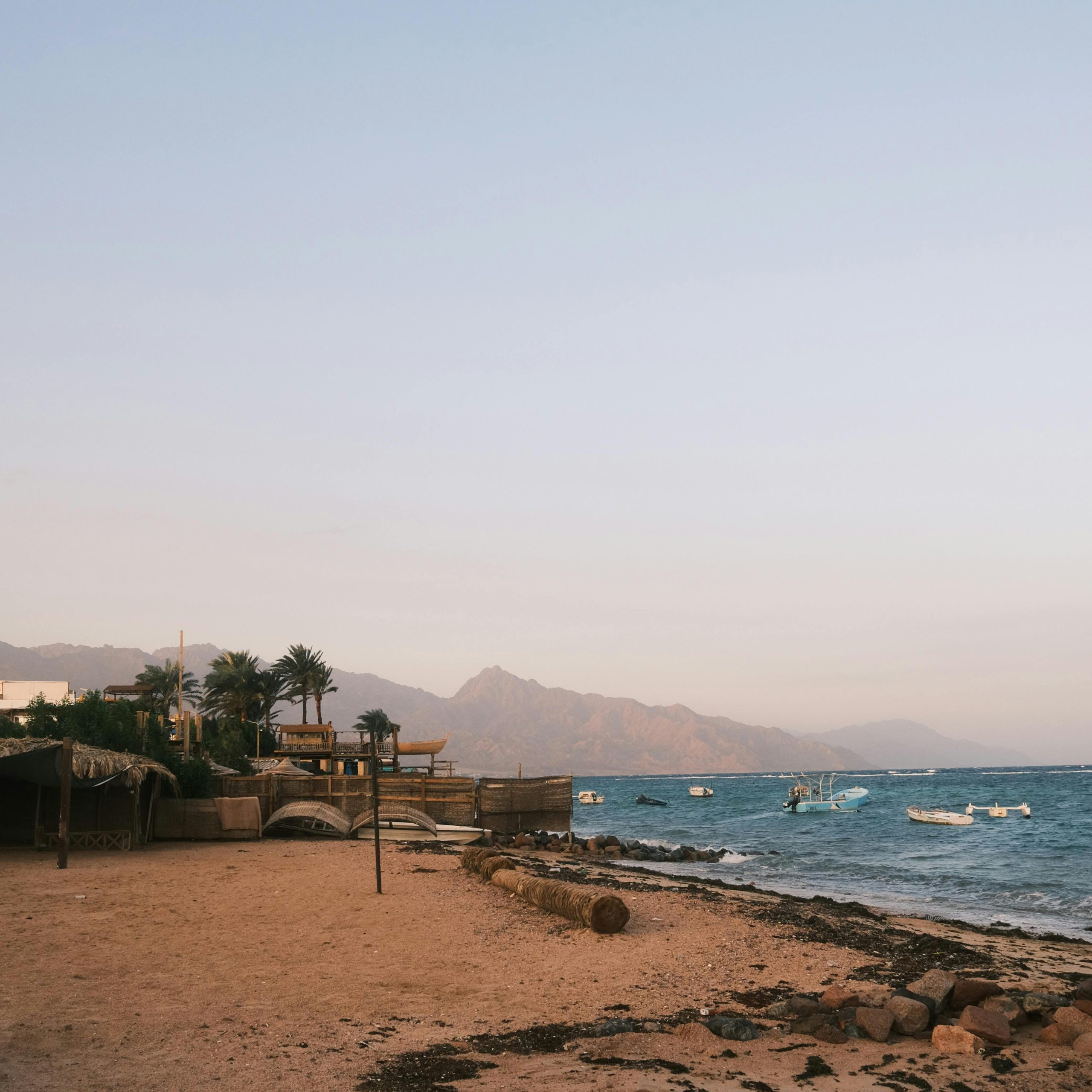 Dahab, Egypt Red Sea coastline with crystal-clear water, coral reefs, and desert mountains