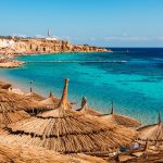 Sandy beaches with clear blue water and palm trees, tropical coastal paradise