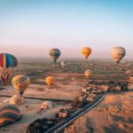 Hot air balloon ride over Luxor at sunrise with panoramic views of ancient temples and the Nile River