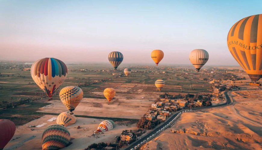 Hot air balloon ride over Luxor at sunrise with panoramic views of ancient temples and the Nile River