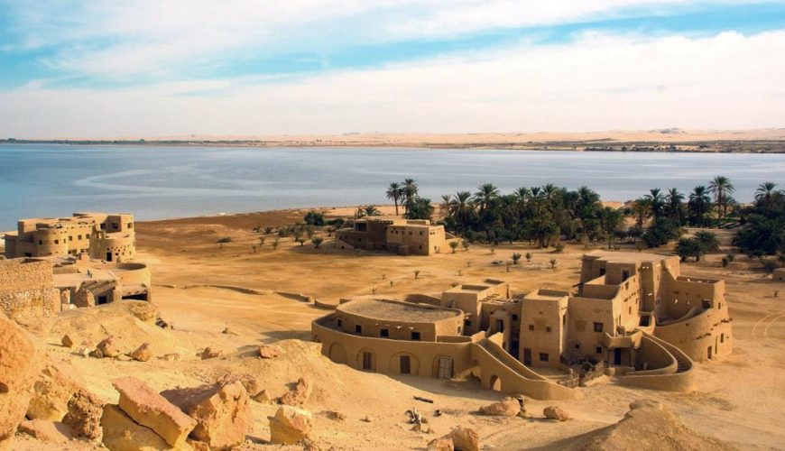 Scenic desert landscape of Siwa Oasis with palm trees and salt lakes in Egypt