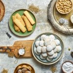 Traditional festive foods for Eid in Egypt including Kahk, Baklava, and Koshari