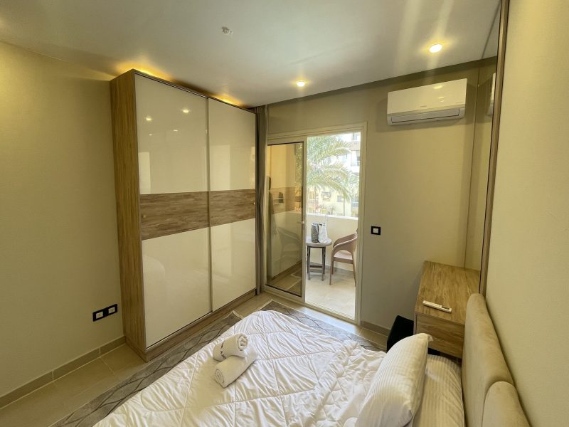 One-bedroom apartment with pool view at Al Karma Beach Resort & Aqua Park Hurghada overlooking resort pools