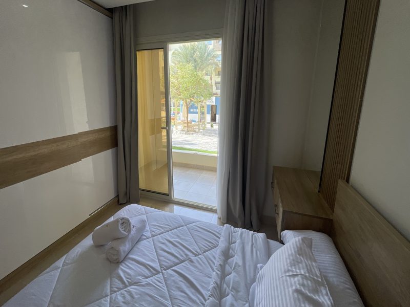 One-bedroom apartment with pool view at Al Karma Beach Resort & Aqua Park Hurghada overlooking resort pools