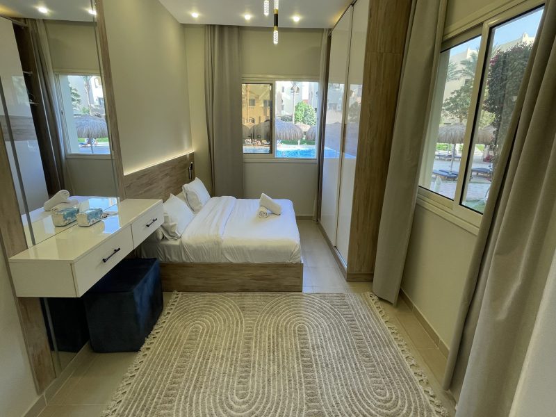 One-bedroom apartment with pool view at Al Karma Beach Resort & Aqua Park Hurghada overlooking resort pools