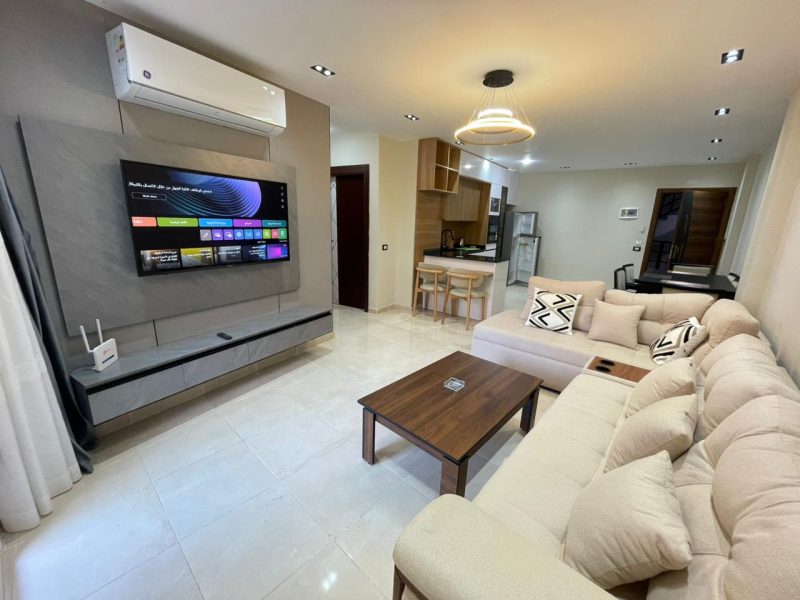 One-bedroom apartment with living room and pool view at Tiba Resort Hurghada featuring spacious layout and modern interior