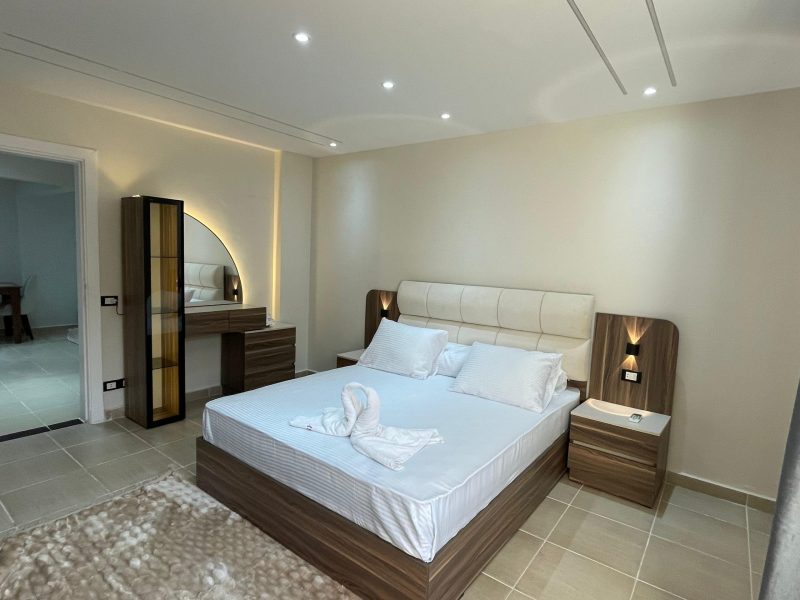 One-bedroom apartment with garden view at Al Karma Beach Resort & Aqua Park Hurghada surrounded by greenery