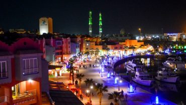 Hurghada Marina at night with illuminated yachts and waterfront restaurants