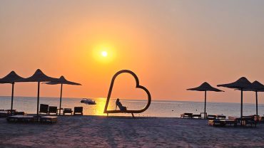 Visitors enjoying the sandy shoreline and clear Red Sea water at Abu Dabbab Beach near Marsa Alam.
