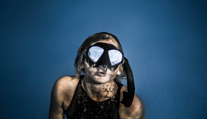 Diving and snorkeling essentials including a mask, snorkel, fins, swimwear, towel, sunscreen, and waterproof bag for a Red Sea excursion in Hurghada.