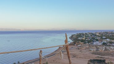 Turquoise Red Sea waters and sandy beaches in Hurghada, Egypt, with boats ready for marine excursions