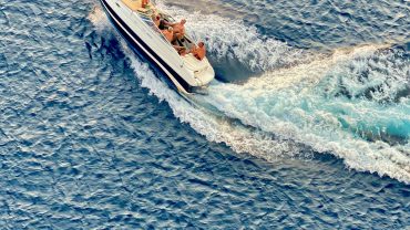 Private speedboat cruising through the clear blue waters of the Maldives on a snorkeling and island adventure.