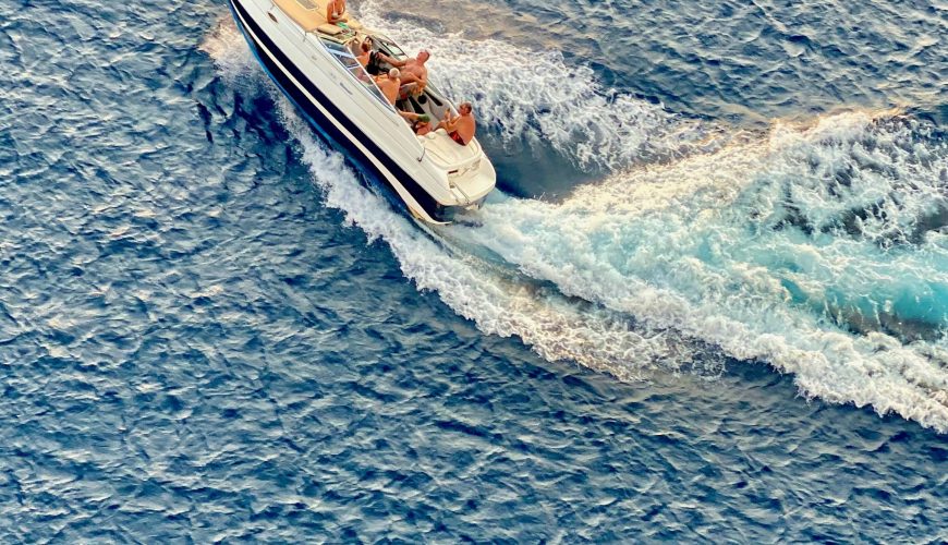 Private speedboat cruising through the clear blue waters of the Maldives on a snorkeling and island adventure.