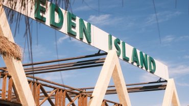 Visitors enjoying an Eden Island boat tour from Hurghada with Red Sea views, beach relaxation, snorkeling, and lunch.
