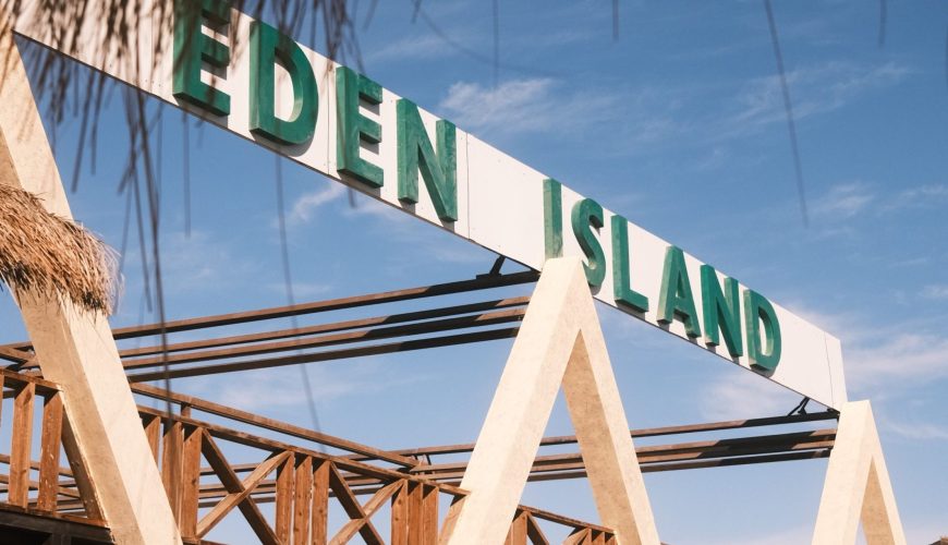 Visitors enjoying an Eden Island boat tour from Hurghada with Red Sea views, beach relaxation, snorkeling, and lunch.